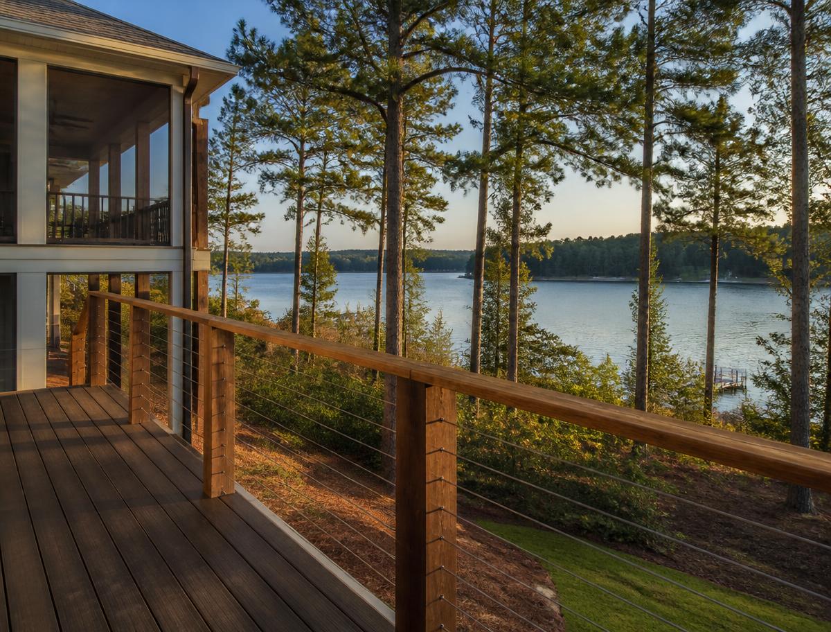 Stainless steel cable railing with wood posts on an elevated lakeside deck